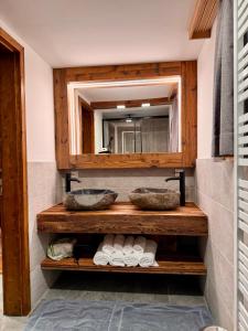 a bathroom with two sinks and a mirror at Alpl Resort in Krieglach