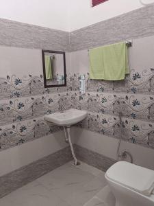 uma casa de banho com um lavatório, um WC e um espelho. em Maa vaishno paying guest house em Ayodhya