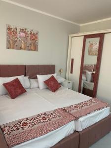 a bedroom with a large bed with red pillows at Scandic beach resort in Hurghada