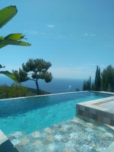 a swimming pool with a view of the ocean at A Eze , Bas de villa piscine près de Monaco in Èze