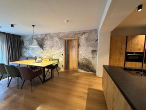 a kitchen and dining room with a table and chairs at Resort Schrofenblick in Mayrhofen