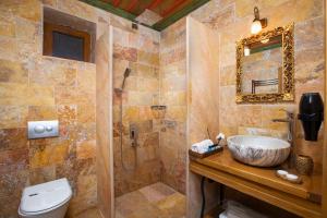 a bathroom with a sink and a toilet and a shower at Katapa Stone House in Goreme