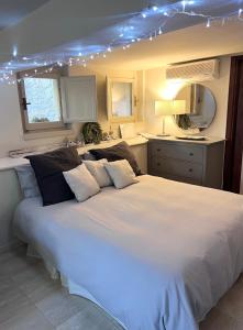 a bedroom with a large white bed with lights on it at la casetta di anita in toscana arezzo in Arezzo