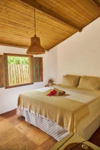 Un dormitorio con una cama grande con ventana. en Casa Baleia - Caraíva - 100m da Igreja, en Caraíva
