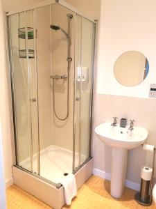 a bathroom with a shower and a sink at Cutlass Court Apartments by Comfort Zone in Birmingham
