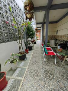 a lobby with chairs and potted plants at Pondok Syariah Hadikusuma 