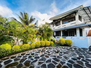 a house with a stone walkway in front of a house at Real Mauritius Apartments in Grand Gaube