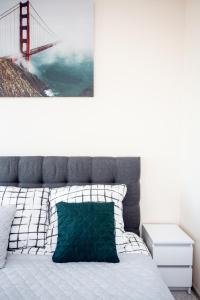 a bed with a picture of the golden gate bridge at Cozy modern Apartment ASTORIA MAGIC GREY OLD TOWN in Krakow