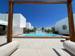 a swimming pool in a villa with blue ceilings at Villa Luna in Lajares