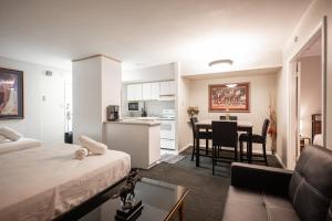 a living room with a bed and a kitchen with a table at Penthouse on the strip - 6 Comfy beds!!! in Las Vegas