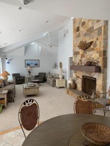 a large living room with a stone fireplace at 866 Rogers in Waretown