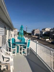 patio con mesa y sillas en el balcón en 2 Bedroom Condo Totally Renovated On Ocean Block In Ship Bottom, en Ship Bottom