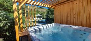 a large hot tub in a backyard with a wooden building at Carmo Country Villas in Ponta Delgada