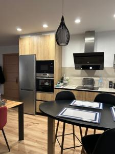 una cocina con una mesa y un refrigerador en Casa Fitero, en Fitero