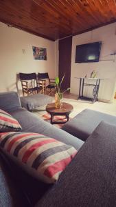 a living room with two couches and a table at Depto confortable para 4 Personas in Posadas