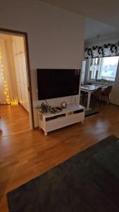 a living room with a large flat screen tv at Adorable Arctic Apartment with sauna in Rovaniemi