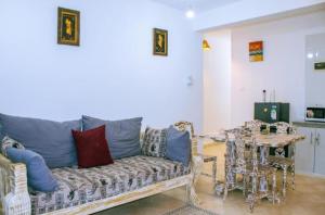 a living room with a couch and a table at PahaliMzuri Kijani - 1 Bedroom Beach Apartment with Swimming Pool in Malindi