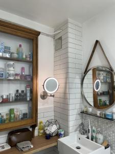 a bathroom with a sink and a mirror at Charming studio Apartment in London in London
