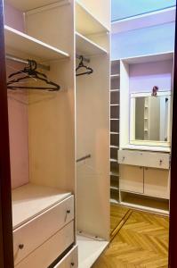 a walk in closet with drawers and a mirror at Sheikh zayed Tata in Sheikh Zayed