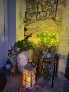 a table with a lantern and some plants and lights at Apartments AMore in Brtonigla