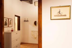 a bathroom with a painting of a woman riding a bike at Casa Vacanze Scolanova in Trani