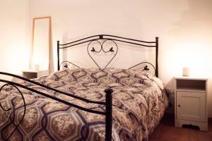a bedroom with a bed with a metal frame at Casa Vacanze Scolanova in Trani +24 photos