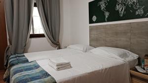 a bed with two towels on it in a bedroom at EURO HOUSE INN airport in Fiumicino