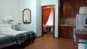 a bedroom with a bed and a sink and a refrigerator at EURO HOUSE INN airport in Fiumicino
