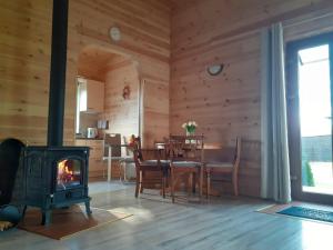 a living room with a stove and a table at Forest Edge Cottage in Riga