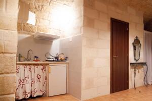 a kitchen with a counter and a sink in a room at Casa Vacanze Scolanova in Trani