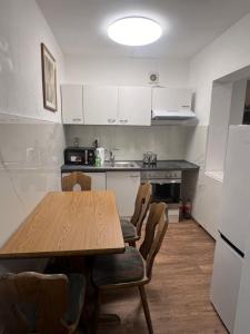 a kitchen with a table and chairs in a room at Messe privat Wohnung Vermietung in Hannover