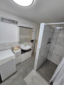 a large white bathroom with a sink and a shower at Ferienwohnung Erna in Marktoberdorf +31 photos