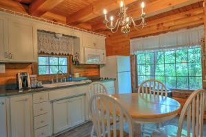 a kitchen with a table and chairs and a dining room at Grapevine Cabin by Amish Country Lodging in Millersburg