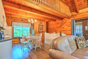 a kitchen and living room with a table and chairs at Grapevine Cabin by Amish Country Lodging in Millersburg