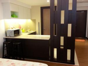 a kitchen with a counter with a microwave on it at Best Studio Guest House in Kota Bharu