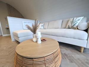 a living room with a couch and a coffee table at Gopsall Hall Farm in Atherstone