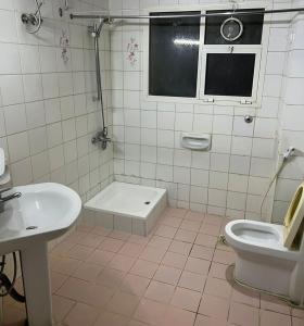 a bathroom with a toilet and a sink at Sport Hotel in Dubai