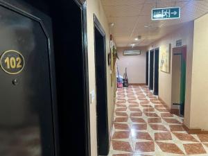 a hallway in a hospital with a sign on the door at Sport Hotel in Dubai