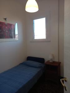 a bedroom with two beds and a window at Attico Vista Mare Sestri Levante in Sestri Levante