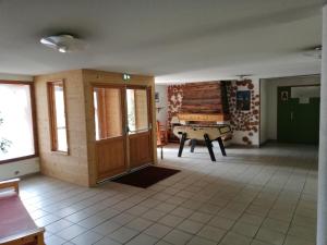 a living room with a ping pong table in it at 2 pièces sur les hauteurs de Saint-François-Longchamp in Saint-François-Longchamp