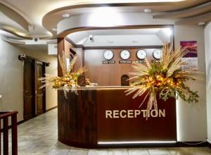 a reception desk in a lobby with clocks on the wall at Time Hotel & Tours in Yerevan