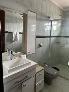 a bathroom with a sink and a toilet and a mirror at Hotel Costa Dalpiaz in Torres +73 photos