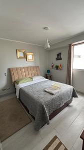 a bedroom with a bed and a window at Departamento en Miraflores con Surquillo in Lima