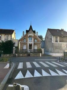an old house with a crosswalk in the middle of a street at Villa rustique,saint-Joseph Enghien in Enghien-les-Bains