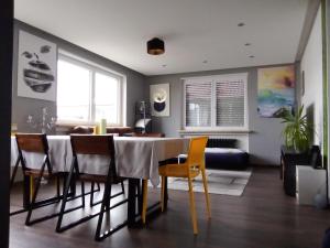 a living room with a dining room table and chairs at MitZeit 2 -95qm inclusive Balkon in Augsburg
