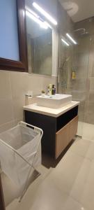 a bathroom with a white sink and a mirror at The Beach House in Muscat