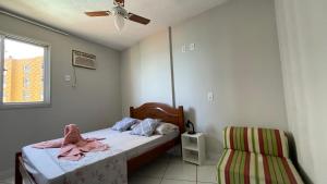 a bedroom with a bed and a chair at STropez com vista pro mar - Praia Areia Preta in Guarapari