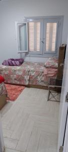 a room with a bed and a chair in it at Nasr city Cozy Studio _ 2 bedrooms in Cairo