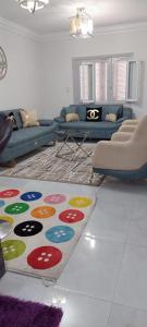 a living room with couches and a rug on the floor at Nasr city Cozy Studio _ 2 bedrooms in Cairo