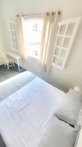 Cama o camas de una habitación en Pousada Genesis Guaruja